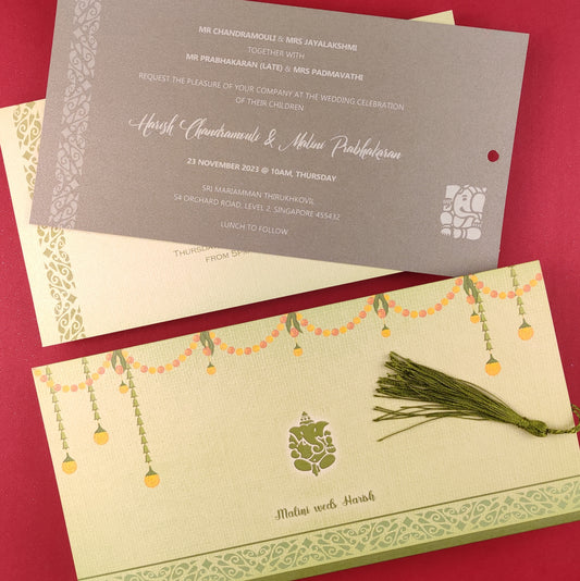 Traditional Indian wedding invitation cards in olive green